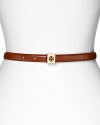Tory Burch's logo-decked skinny leather belt adds subtle hit of luxe. For easy chic, loop the understated style through dark denim and simple separates.