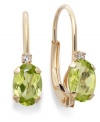 Sparkling perfection. Add a vibrant pop of color to your look with oval-cut peridots (3/4 ct. t.w.) and sparkling diamond accents. Crafted in a 14k gold leverback setting. Approximate drop: 3/4 inch.