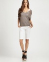 Semi-sheer v-neck with short dolman sleeves, ribbed trim and a captivating v-back. V-neckDropped shouldersShort sleevesRibbed cuffs and hemV-back65% rayon/35% LurexDry cleanImportedModel shown is 5'11 (180cm) wearing US size Small.
