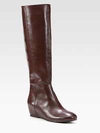 Classic elegance and ease combine in this sleek leather silhouette with a hidden wedge and side zip. Hidden wedge, 2¾ (70mm)Shaft, 17Leg circumference, 15Leather upperSide zipLeather liningRubber solePadded insoleImportedThis style runs true to size. We recommend ordering your usual size for a standard fit. Classic elegance and ease combine in this sleek leather silhouette with a hidden wedge and side zip. Hidden wedge, 2¾ (70mm)Shaft, 17Leg circumference, 15Leather upperSide zipLeather liningRubber solePadded insoleImportedThis style runs true to size. We recommend ordering your usual size for a standard fit.