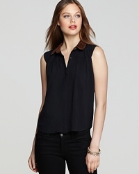 This DV Dolce Vita sleeveless button-up top is boldly punctuated by a leopard-print collar for a hint of the exotic. This DV Dolce Vita sleeveless button-up top is boldly punctuated by a leopard-print collar for a hint of the exotic.