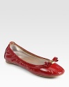 High-gloss patent leather flat has a stretchy upper and logoed bow adornment. Patent leather upperLeather liningRubber solePadded insoleImportedOUR FIT MODEL RECOMMENDS ordering true size. 