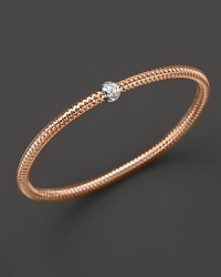 A single diamond station shines on this modern 18K rose gold mesh bangle from Roberto Coin. A single diamond station shines on this modern 18K rose gold mesh bangle from Roberto Coin.