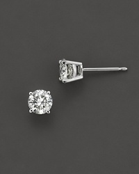 Traditional four prong round diamond stud earring in a white gold setting.