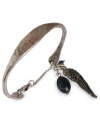 Take flight with this wing charm cuff bracelet from Lucky Brand. Crafted from silver-tone mixed metal, the bracelet features semi-precious calcite, azurite and lapis elements for a stylish touch. Approximate diameter: 2-5/8 inches.