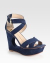 Supported by an artful cutout wedge and platform, this velvety suede silhouette has intertwining criss-cross straps and an adjustable ankle strap. Self-covered wedge, 4 (100mm)Covered platform, 1 (25mm)Compares to a 3 heel (75mm)Suede upperLeather lining and solePadded insoleImported
