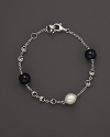 A bold sterling silver chain bracelet, gleaming with blue tigers eye and freshwater pearl. By Di MODOLO.