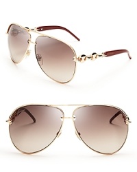 Gucci's aviator sunglasses shine in gold with the luxury brand's signature chain link details. Gucci's aviator sunglasses shine in gold with the luxury brand's signature chain link details.