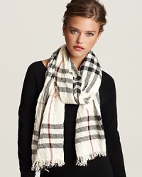 Burberry ups the glam factor with this check scarf in crinkled fabric with fringe trim. Let the signature pattern and luxurious proportions transform your look.