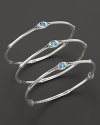 From the Batu Bamboo collection, a set of three slim bamboo bangles with blue topaz accents. Designed by John Hardy