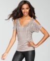 Sexy cutouts and edgy studs create a unique combination of tough and tender on INC's party-ready top!