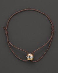 A tricolor gold pendant with diamonds accents this modern leather cord bracelet from Georg Jensen. A tricolor gold pendant with diamonds accents this modern leather cord bracelet from Georg Jensen.