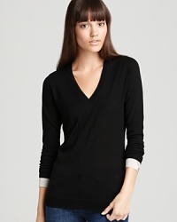 An essential additional to your knitwear repertoire, this Burberry Brit sweater features a sumptuous merino wool silhouette trimmed with check-lined cuffs for signature style. An essential additional to your knitwear repertoire, this Burberry Brit sweater features a sumptuous merino wool silhouette trimmed with check-lined cuffs for signature style.