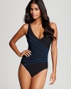 Gottex lends this classically styled one piece swimsuit stylish-meets-flattering detail with a sweep of stripes defining the waistline.