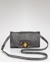 Tory Burch adds a touch of easy elegance to any look with this clutch, styled in subtle, stingray-embossed leather. The turnlock closure opens to a lined interior with a zip pocket and two slip pockets.