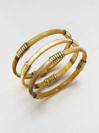 A set of three slender bangles of richly mottled natural horn, wrapped here and there in shiny flat brass wire.Recycled cow hornBrassDiameter, about 2.5Slip-on styleImported A set of three slender bangles of richly mottled natural horn, wrapped here and there in shiny flat brass wire.Recycled cow hornBrassDiameter, about 2.5Slip-on styleImported