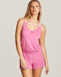 A sporty romper gets a girlish touch with floral lace racerback, straps and patch pocket at back. A sporty romper gets a girlish touch with floral lace racerback, straps and patch pocket at back.