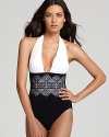 Cut a sophisticated figure in this Gottex one piece swimsuit with a stylish laser-cut lace overlay. A white padded halter top highlights your best assets as the black bottom minimizes in an ultra-flattering look.
