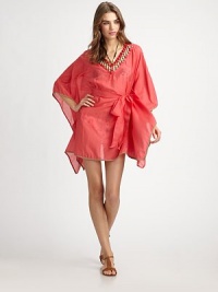 An unmistakable must-have thanks to gorgeous beading and a waist-accentuating self-tie belt, this flattering coverup has it all. Beaded v-neckBraided trimSelf-tie belt on elasticized waist70% cotton/30% silkDry cleanMade in USA of imported fabric An unmistakable must-have thanks to gorgeous beading and a waist-accentuating self-tie belt, this flattering coverup has it all. Beaded v-neckBraided trimSelf-tie belt on elasticized waist70% cotton/30% silkDry cleanMade in USA of imported fabric
