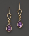 Bezeled amethyst teardrops, framed in 14K yellow gold.