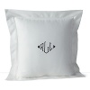 A solid pique throw pillow with a hemstitch border and embroidered navy monogram adds classic style.