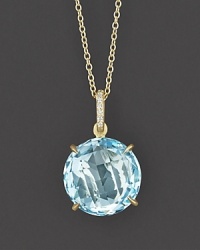 Sparkling pavé diamonds and a sky blue topaz are set in 18K yellow gold. Sparkling pavé diamonds and a sky blue topaz are set in 18K yellow gold.