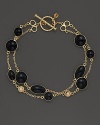Two rows of black enamel stations and diamond accents highlight this bracelet from Roberto Coin.