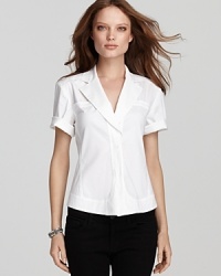 Donna Karan New York gives the classic white button-down a modern makeover, lending it spring-ready style with short, rolled sleeves and a fitted silhouette. Paired with little black pants or a sleek pencil skirt, the look epitomizes classic versatility.