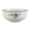 Delicate dark blue floral sprays adorn this timeless bowl made from premium porcelain, perfect for morning cereal or evening soups.