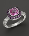 A sterling silver ring with cushion-cut pink corundum stone and amethyst pave frame. By Judith Ripka.