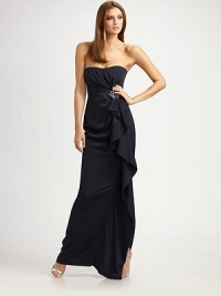 An elegant evening style in a strapless silhouette with a dazzling brooch at the waist.Strapless, sweetheart neckline Gathered bodice Brooch detail at waist Draping along side skirt Side slit Back zip closure About 54 from shoulder to hem Polyester; dry clean Imported An elegant evening style in a strapless silhouette with a dazzling brooch at the waist.Strapless, sweetheart neckline Gathered bodice Brooch detail at waist Draping along side skirt Side slit Back zip closure About 54 from shoulder to hem Polyester; dry clean Imported