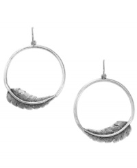 Free-spirited and fancy free. Fossil's breezy earring style features a hoop setting with intricate feather accents. Set in silver tone mixed metal. Approximate diameter: 1-3/4 inches.