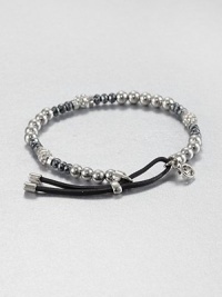 From the Brilliance Collection. A mix of silvery beads includes faceted hematite, smooth stainless steel and rhinestone-crusted spheres, strung on a stretchy strand with a leather slide close.HematiteGlassSilvertone and stainless steelLeatherDiameter, about 2.25Imported