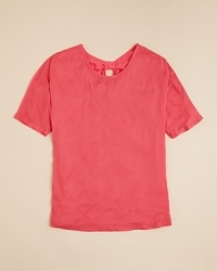 Pretty proportions that turn heads everytime. This solid chiffon top shapes up with a back chiffon inset and back cutouts gathered with tonal bow accents. Pretty proportions that turn heads everytime. This solid chiffon top shapes up with a back chiffon inset and back cutouts gathered with tonal bow accents.