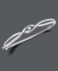 Simplicity and style twisted into one. Bangle by Wrapped in Love™ features two bands of sterling silver sweeping past one another with a glittering round-cut diamond (1/10 ct. t.w.) at their intersection. Approximate width: 2-3/8 inches. Simplicity and style twisted into one. Bangle by Wrapped in Love™ features two bands of sterling silver sweeping past one another with a glittering round-cut diamond (1/10 ct. t.w.) at their intersection. Approximate width: 2-3/8 inches.