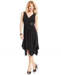 Jessica Howard's dress features a gorgeous draped skirt that descends to a handkerchief hem. A ruched empire waist with a brooch-like beaded embellishment keeps the silhouette looking sleek and defined! Jessica Howard's dress features a gorgeous draped skirt that descends to a handkerchief hem. A ruched empire waist with a brooch-like beaded embellishment keeps the silhouette looking sleek and defined!