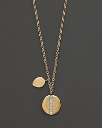 Gold medallion necklace with diamond accents, paired with an additional gold charm. Designed by Meira T. Gold medallion necklace with diamond accents, paired with an additional gold charm. Designed by Meira T.