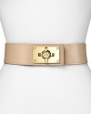 A bold turnlock asserts tough-girl glamour on this Tory Burch belt, composed of smooth leather and elastic. It's an edgy must-have over a body-con mini dress with towering stiletto booties.