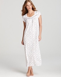 A wondrous floral print blooms across Eileen West's short-sleeve nightgown, laced with ribbon at the neckline. A wondrous floral print blooms across Eileen West's short-sleeve nightgown, laced with ribbon at the neckline.