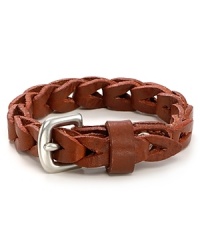 This braided leather bracelet is offset by a gold metal buckle for a classic masculine look. This braided leather bracelet is offset by a gold metal buckle for a classic masculine look.