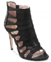 Luxurious and sparkly. Vince Camuto's Lanai evening sandals feature a caged upper a pretty glitter-covered heel.