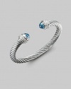 From the Silver Ice Collection. A bold twisted cable of sterling silver, capped with faceted blue topaz and banded with pavé diamonds. Diamonds, 0.48 tcw Blue topaz Sterling silver Cable, 7mm Diameter, about 2¼ Made in USA