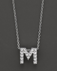 From the Tiny Treasures collection, a diamond M necklace. With signature ruby accent. Designed by Roberto Coin.