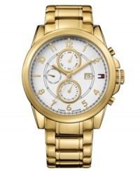 Handsome timepiece in an always-classic design from Tommy Hilfiger. Crafted of gold tone stainless steel bracelet and round case. White chronograph dial features three subdials, gold tone three hands, applied numerals, minute track, iconic flag logo and date window at three o'clock. Quartz movement. Water resistant to 50 meters. Ten-year limited warranty. Handsome timepiece in an always-classic design from Tommy Hilfiger. Crafted of gold tone stainless steel bracelet and round case. White chronograph dial features three subdials, gold tone three hands, applied numerals, minute track, iconic flag logo and date window at three o'clock. Quartz movement. Water resistant to 50 meters. Ten-year limited warranty.