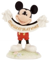 A cute memento of a major accomplishment, Mickey Mouse extends his congratulations with a gold-lettered banner in this fine china Disney figurine by Lenox. A cute memento of a major accomplishment, Mickey Mouse extends his congratulations with a gold-lettered banner in this fine china Disney figurine by Lenox.