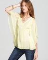 Airy layers cascade gently over your silhouette when you wear this Free People top, embellished with beads at the neckline for a unique touch. Pair with your favorite denim to lift the off-duty look.