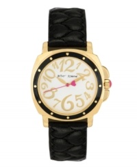 A little old-fashioned and a little over-the-top. Watch by Betsey Johnson crafted of black quilted leather strap and round polished gold tone mixed metal case with black bezel. White dial features whimsical gold tone numerals, gold tone hour and minute hands, pink second hand with heart and logo. Quartz movement. Water resistant to 30 meters. Two-year limited warranty. A little old-fashioned and a little over-the-top. Watch by Betsey Johnson crafted of black quilted leather strap and round polished gold tone mixed metal case with black bezel. White dial features whimsical gold tone numerals, gold tone hour and minute hands, pink second hand with heart and logo. Quartz movement. Water resistant to 30 meters. Two-year limited warranty.