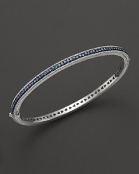Blue sapphires stud a sterling silver bangle from Judith Ripka. Blue sapphires stud a sterling silver bangle from Judith Ripka.