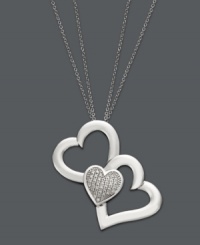 You'll do a triple take when you see this unique version of the iconic heart pendant. Treasured Hearts' beautifully-crafted design features two cut-out hearts and one solid heart dusted with sparkling, round-cut diamonds (1/5 ct. t.w.). Setting and chain crafted in sterling silver. Approximate length: 24 inches. Approximate drop: 1-1/4 inches.