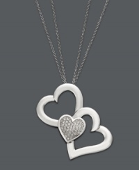 You'll do a triple take when you see this unique version of the iconic heart pendant. Treasured Hearts' beautifully-crafted design features two cut-out hearts and one solid heart dusted with sparkling, round-cut diamonds (1/5 ct. t.w.). Setting and chain crafted in sterling silver. Approximate length: 24 inches. Approximate drop: 1-1/4 inches. You'll do a triple take when you see this unique version of the iconic heart pendant. Treasured Hearts' beautifully-crafted design features two cut-out hearts and one solid heart dusted with sparkling, round-cut diamonds (1/5 ct. t.w.). Setting and chain crafted in sterling silver. Approximate length: 24 inches. Approximate drop: 1-1/4 inches.
